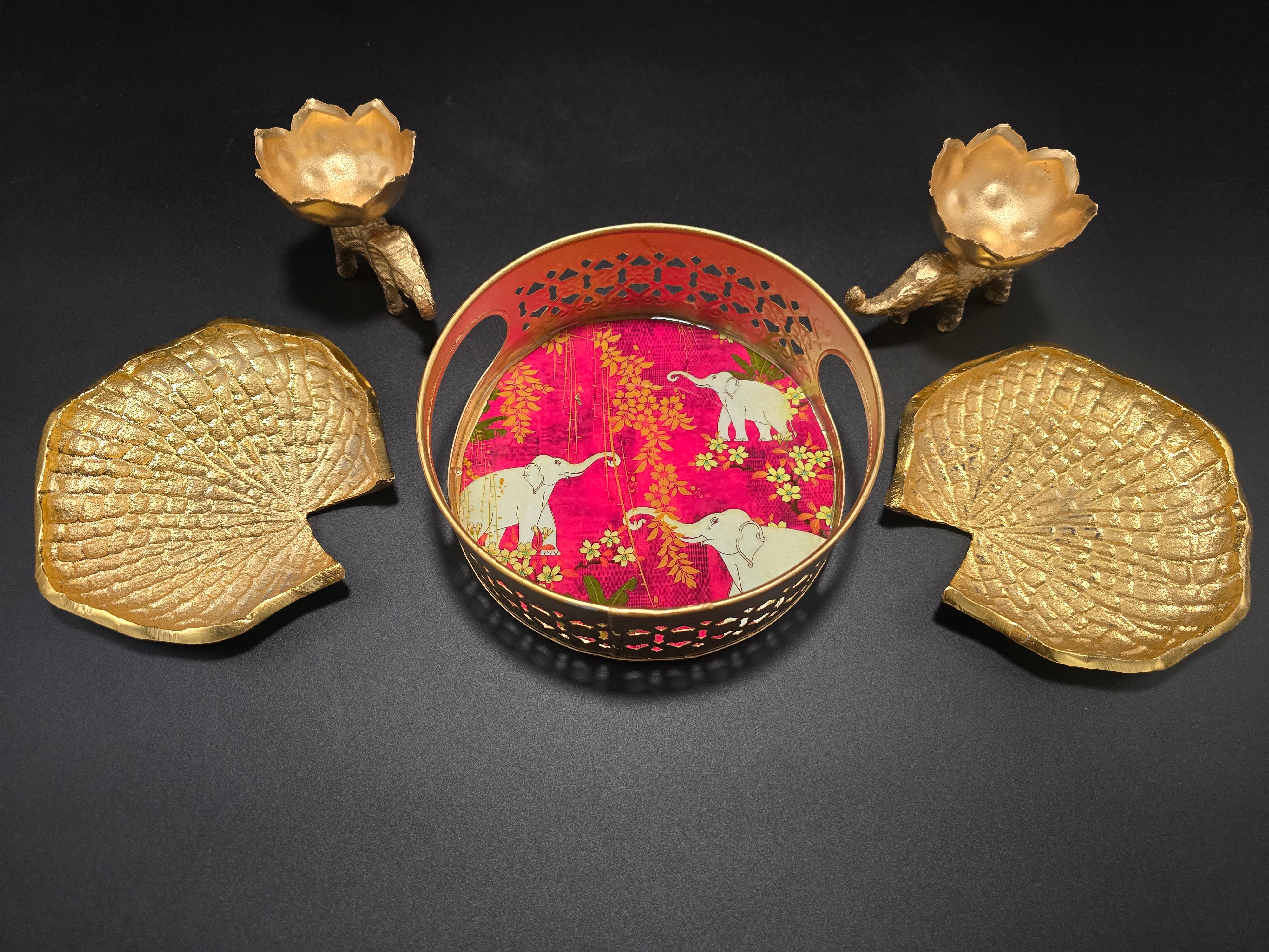 Premium Diwali gift set showing five pieces including two elephant diyas two peacock coasters decorative basket with elephant design all in gold finish
