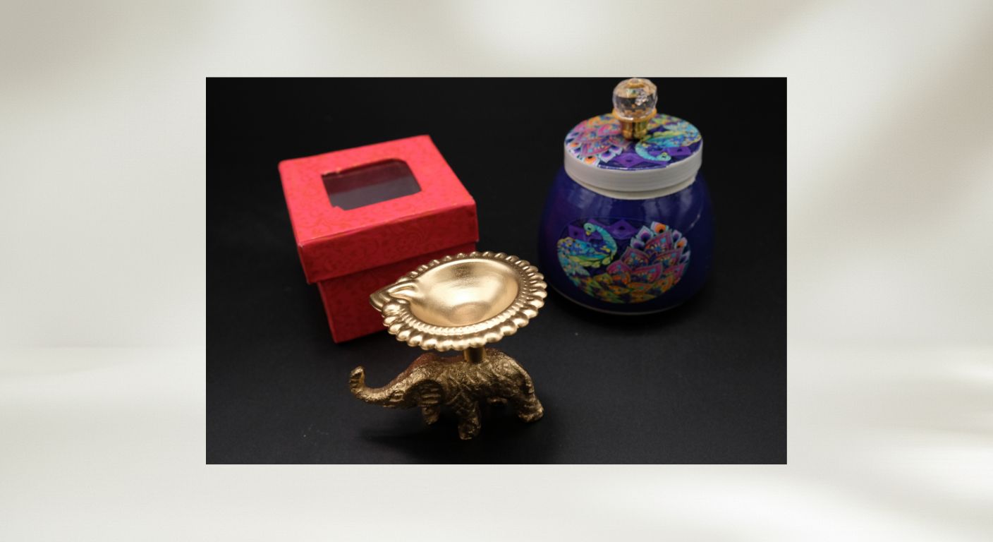 Budget Diwali favor gift showing blue peacock design jar with elephant diya in organza bag ready to give