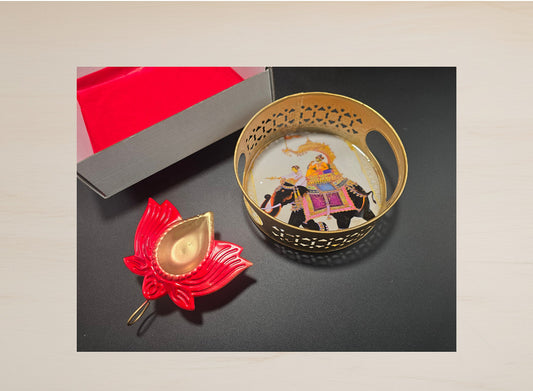 Diwali favor gift showing decorative gold lattice basket with large 4 inch vibrant red lotus diya and elephant print gift box