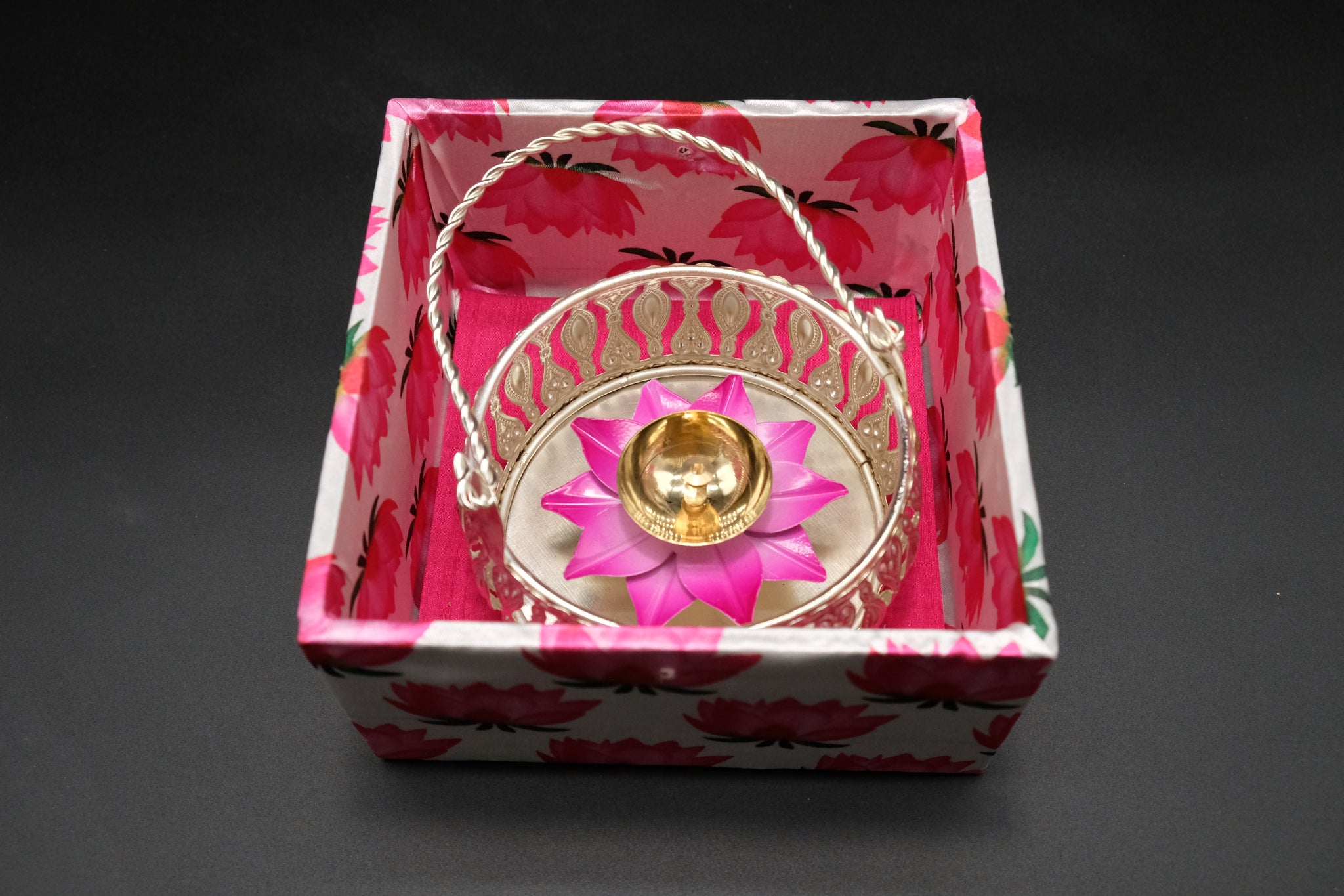 Diwali party favor basket with lotus diya nestled in decorative gift-ready box showing premium packaging presentation