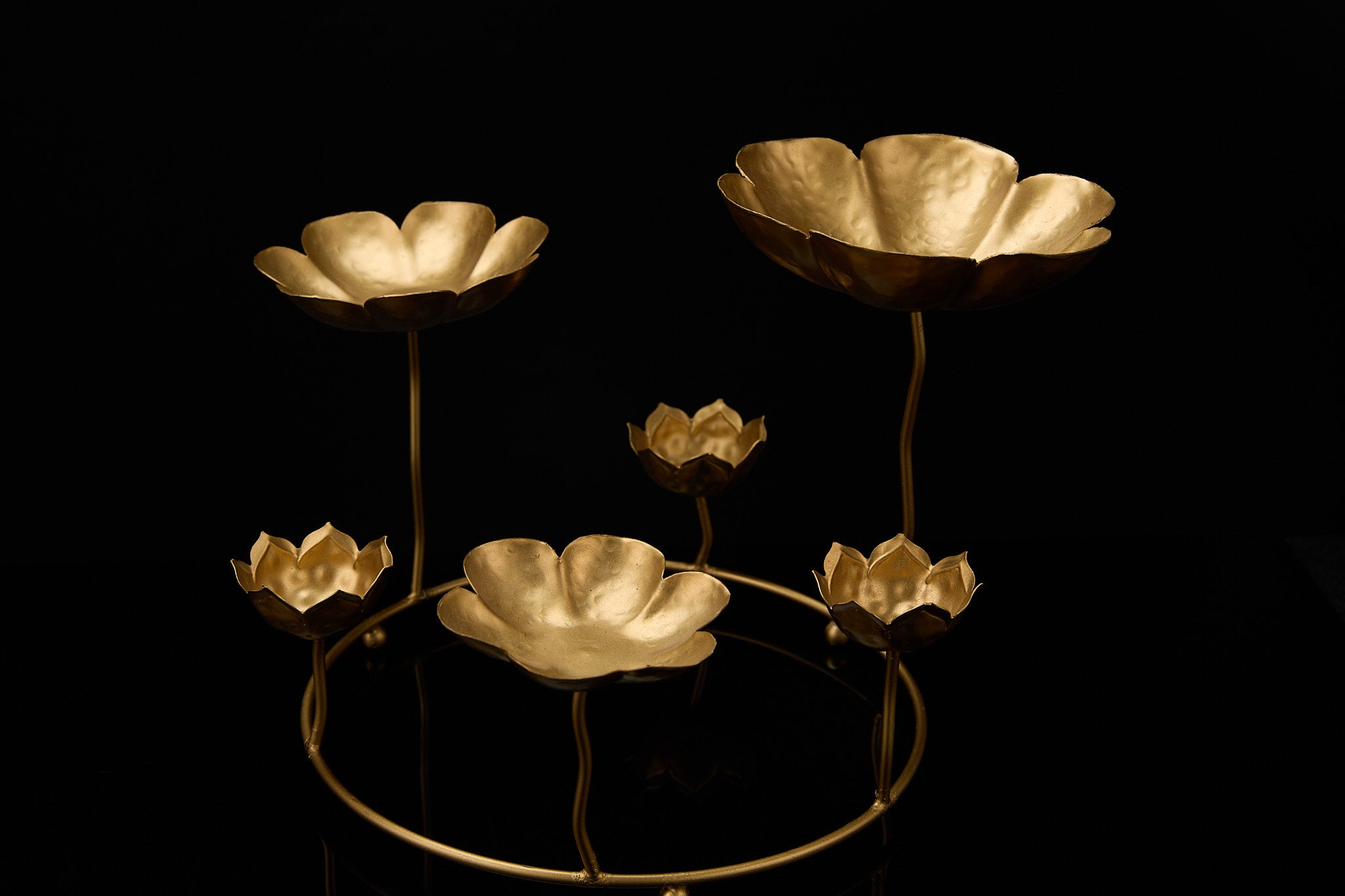 Standing lotus urli centerpiece showing nine inch tall multi-tier gold sculpture with lotus bowls on curved stems for premium Diwali decor
