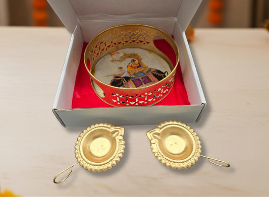 Traditional Diwali favor gift showing gold tray in box and pair of gold leaf diyas displayed for symmetrical arrangement