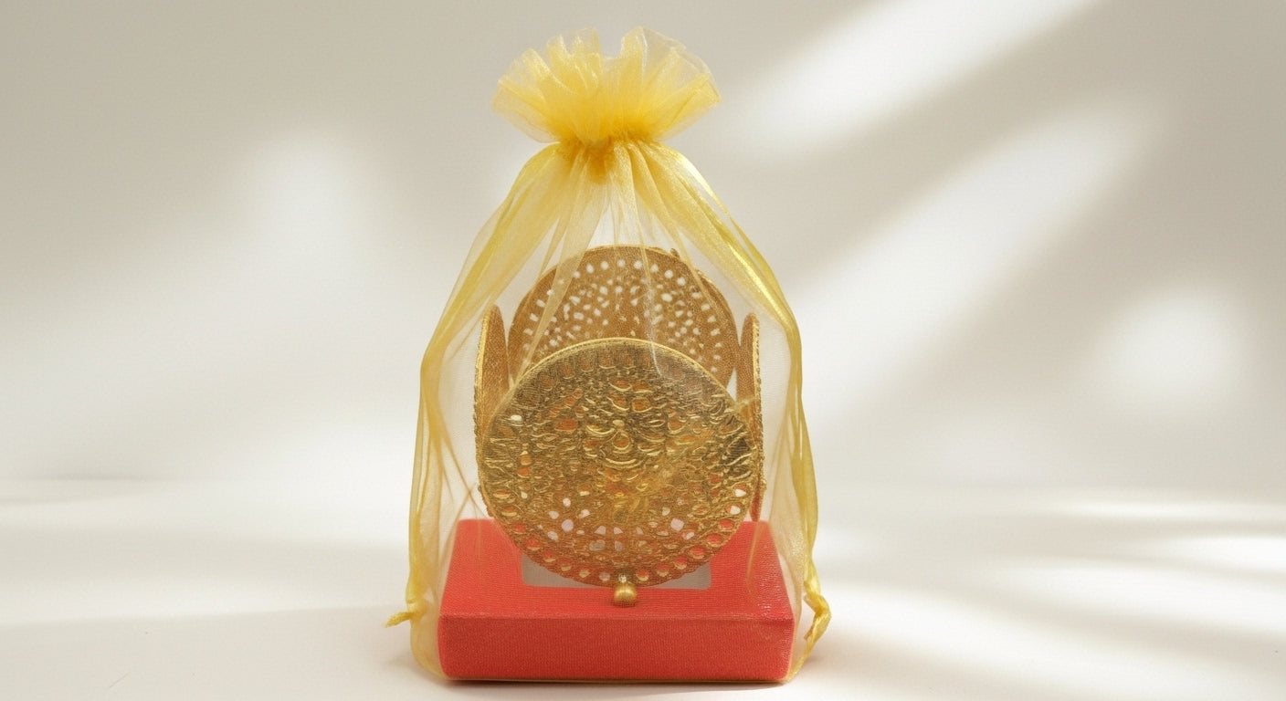 Complete Diwali favor gift showing decorative filigree diya set with red gift box in cream organza bag ready to give