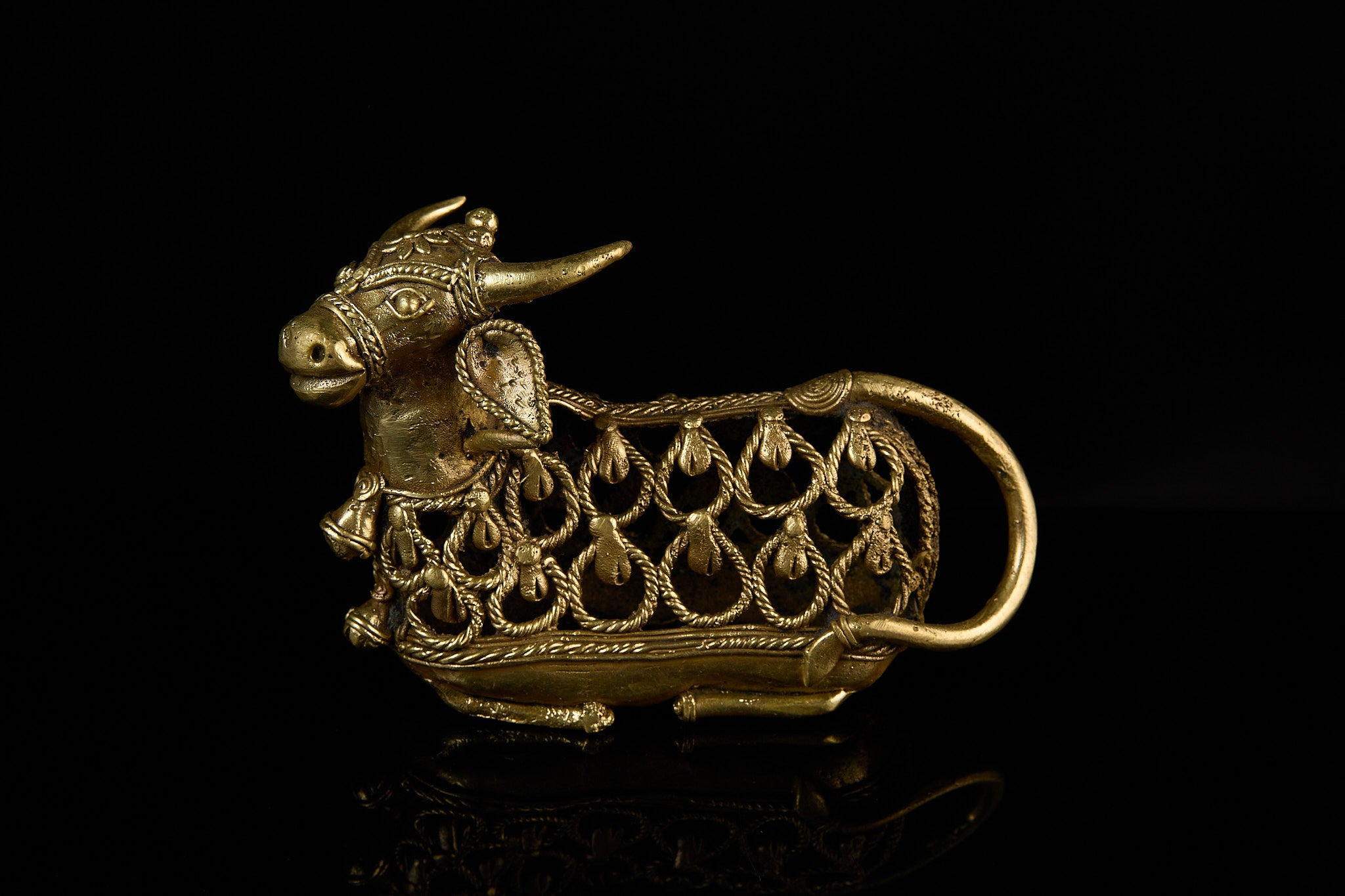A sturdy, grounded view of the Nandi Bull idol, focusing on its ornate body and the small bells adorning its neck.