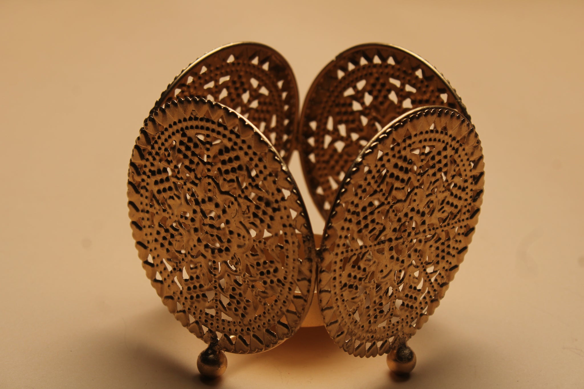 Three dual diya favor sets in vibrant organza bags showing blue pink and yellow colors with handcrafted fabric and metal diyas for Diwali favors