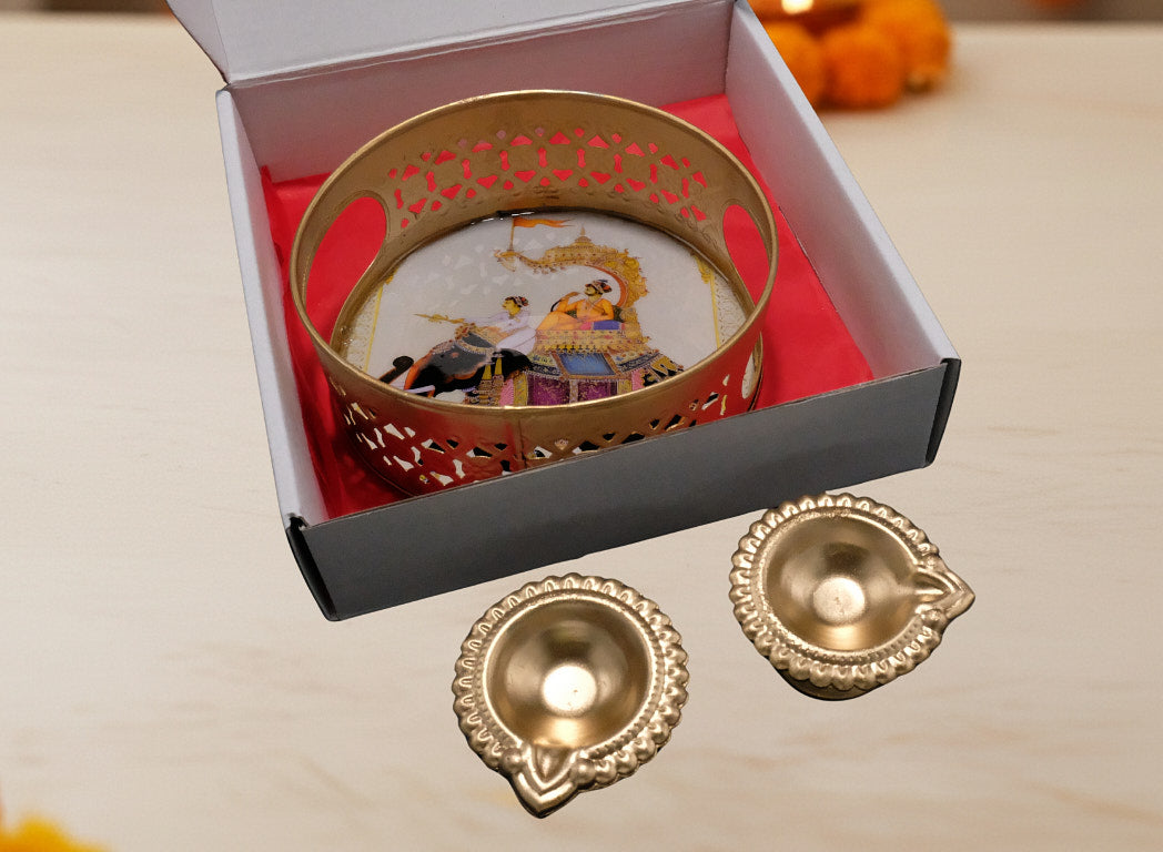 Traditional Diwali favor tray with 2 gold diyas outside elephant print box showing red satin lining and complete gift presentation