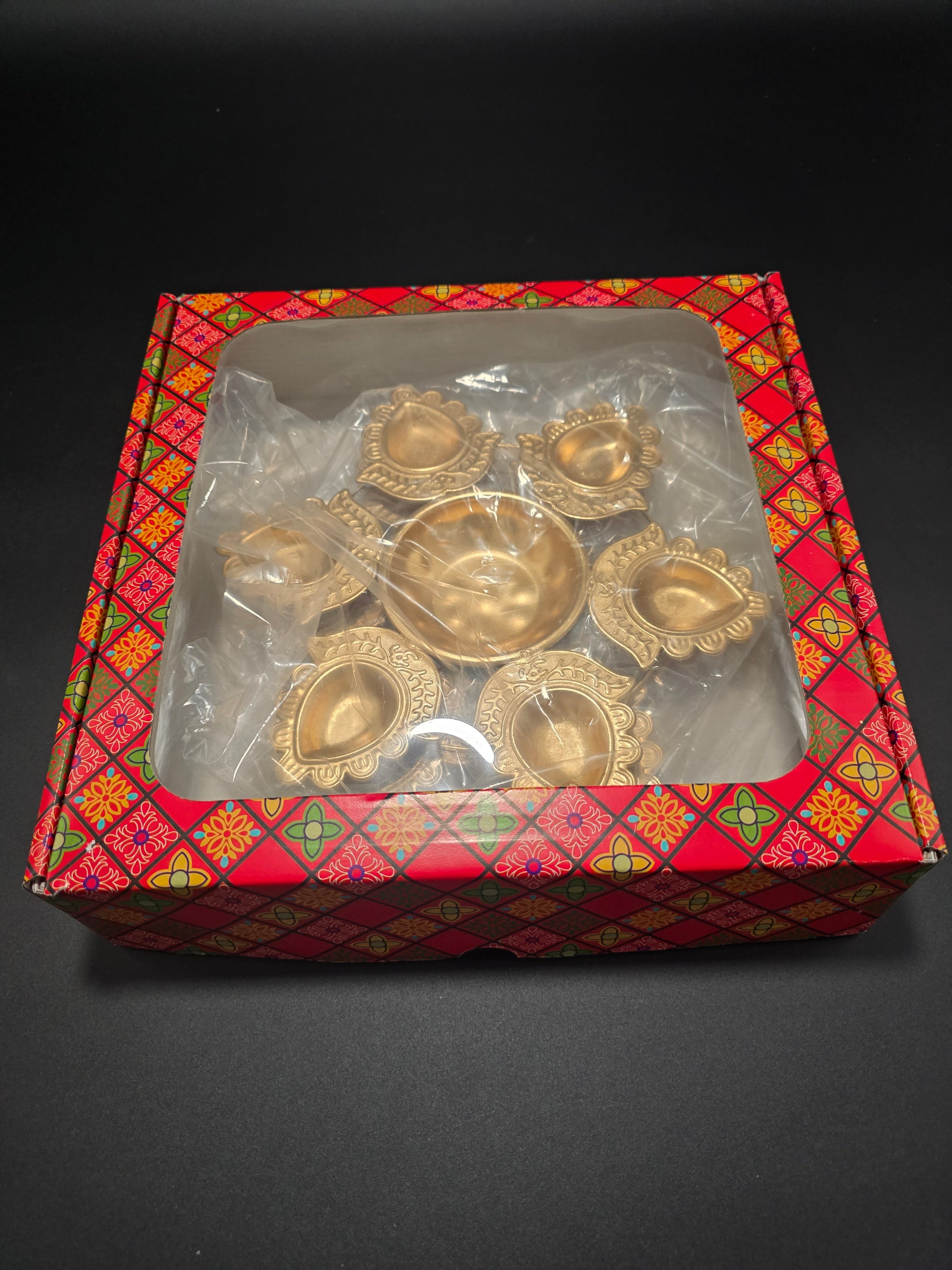 Two traditional rangoli urli diya plates with mandala design in decorative gift box for authentic Diwali oil lamp ceremonies