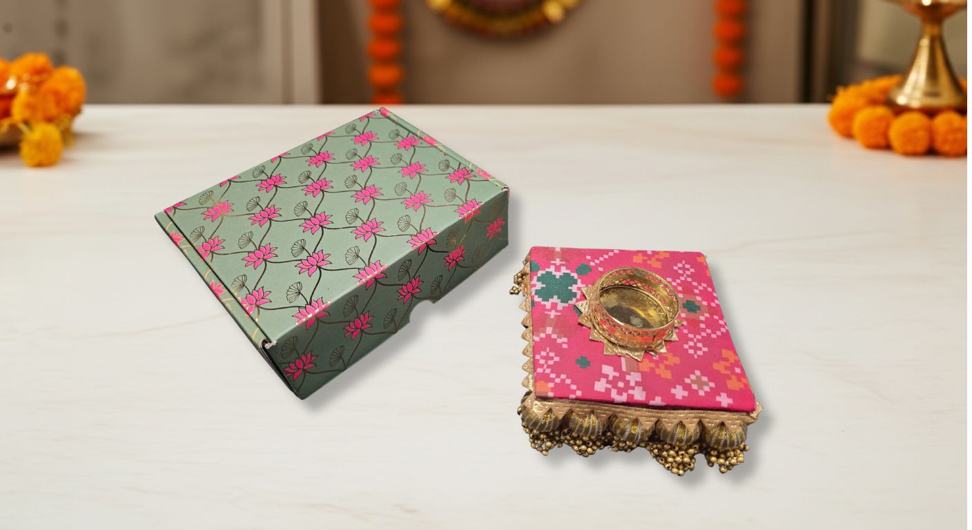 Handcrafted fabric diya with traditional gota work trim and tassels in pink geometric pattern for Diwali favor gifts