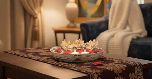 Distressed white lotus urli displayed on coffee table with lit tea lights in contemporary neutral living room showing farmhouse aesthetic
