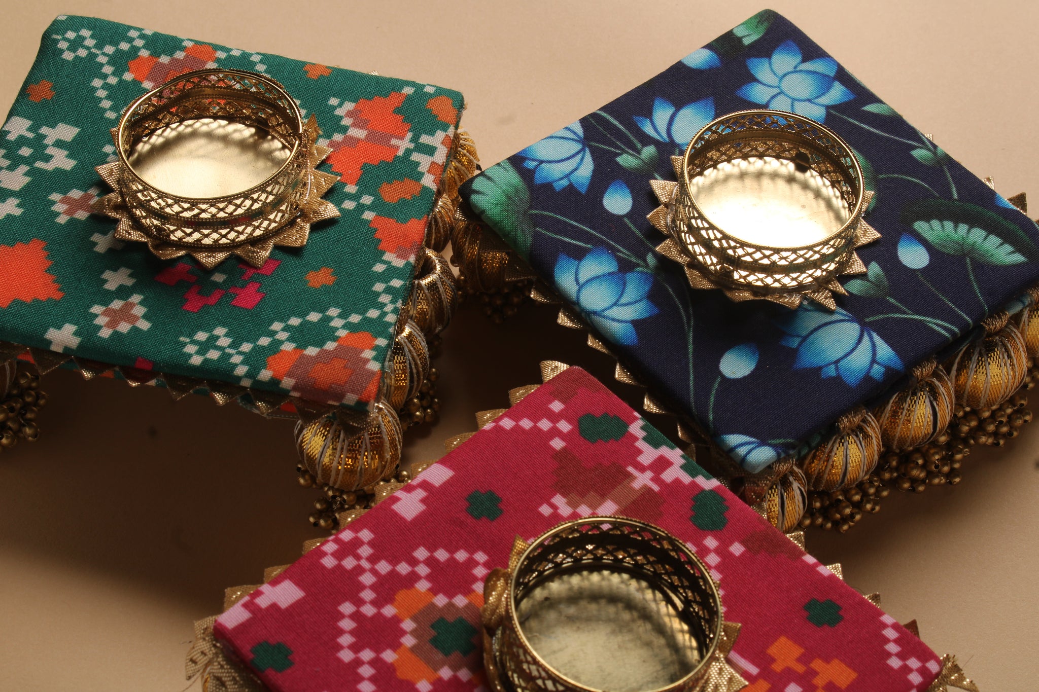 Assorted handcrafted fabric diyas with gota work showing three different traditional Indian pattern variations for Diwali favors