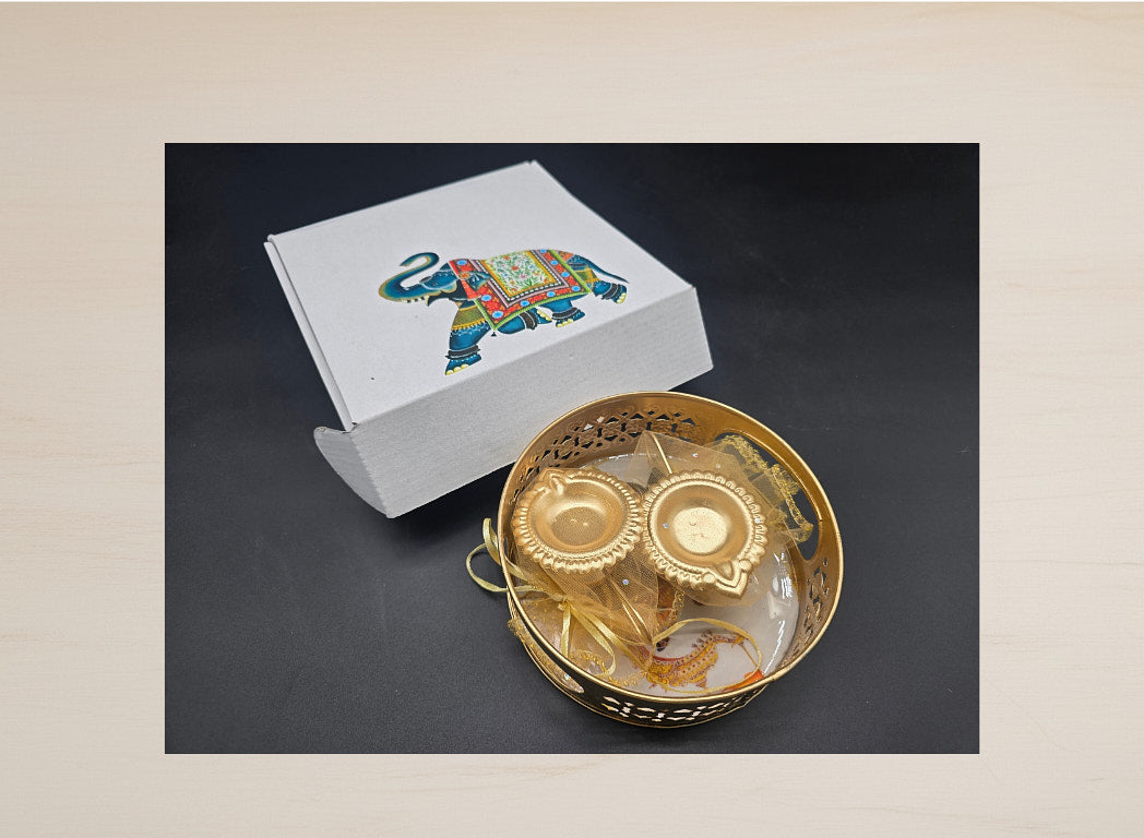 Complete Diwali favor set with gold tray two gold leaf diyas and elephant print decorative gift box