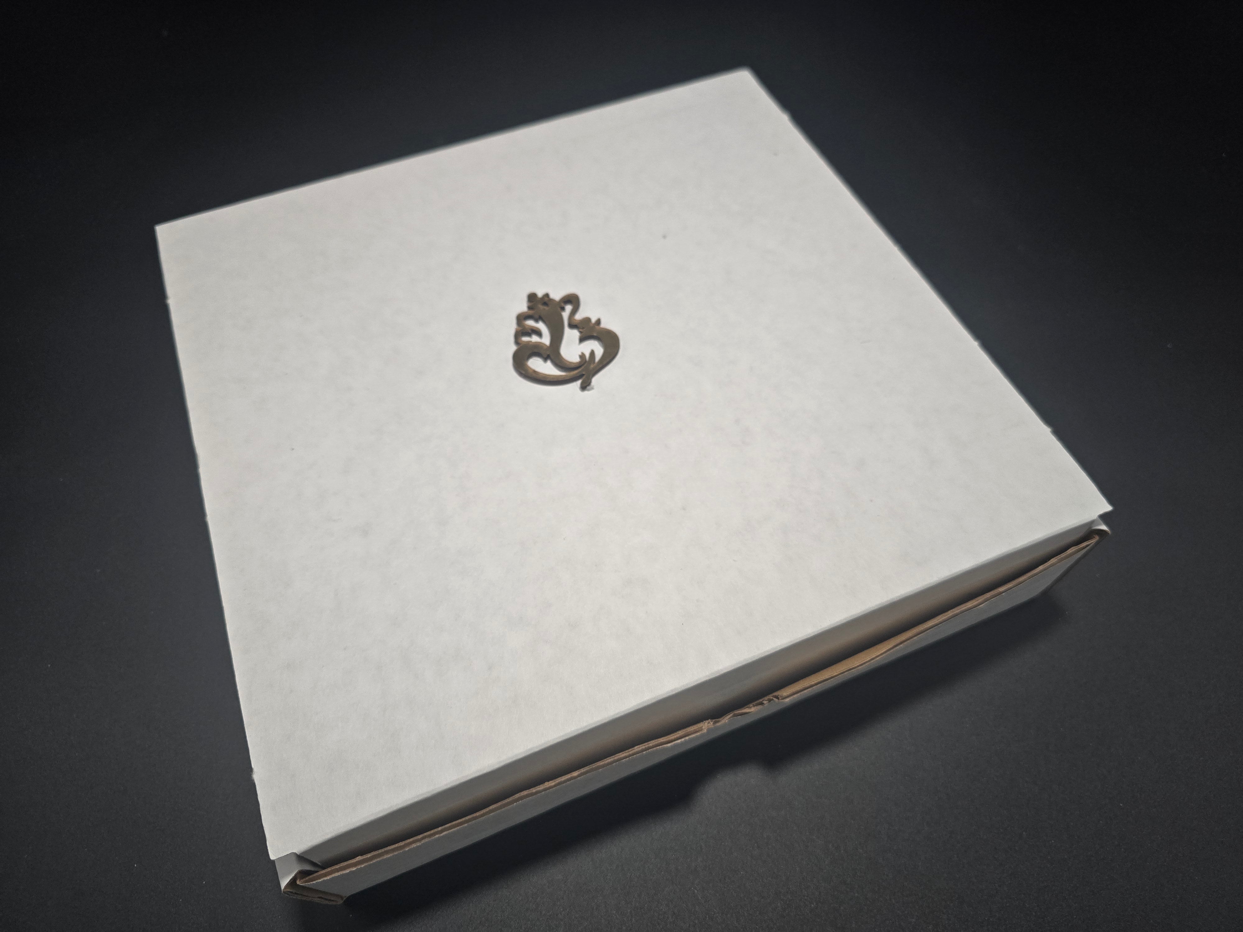 Premium white gift box with embossed Ganesha symbol containing complete Diwali decor set ready for hostess gifting